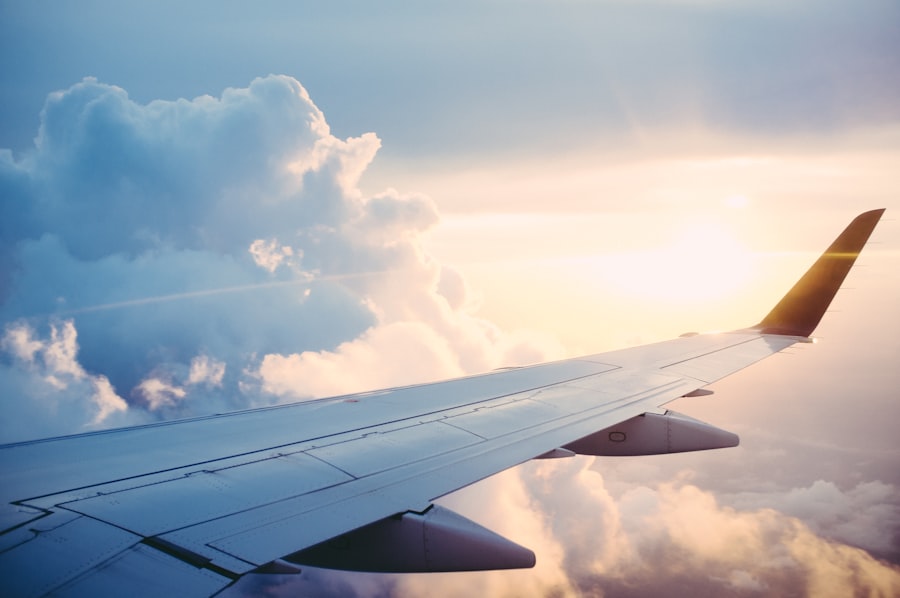 Aircraft wing over clouds at sunset